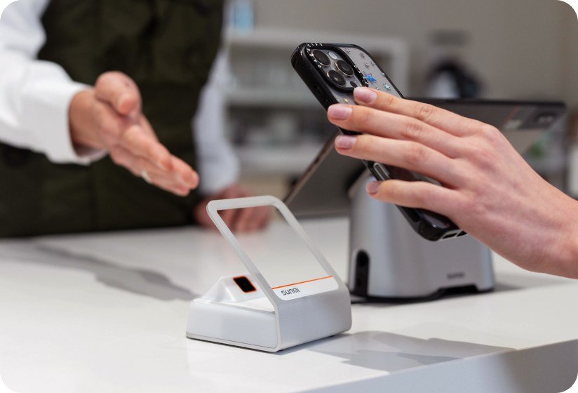 Sunmi Blink 2 reading a phone barcode on a clean retail counter