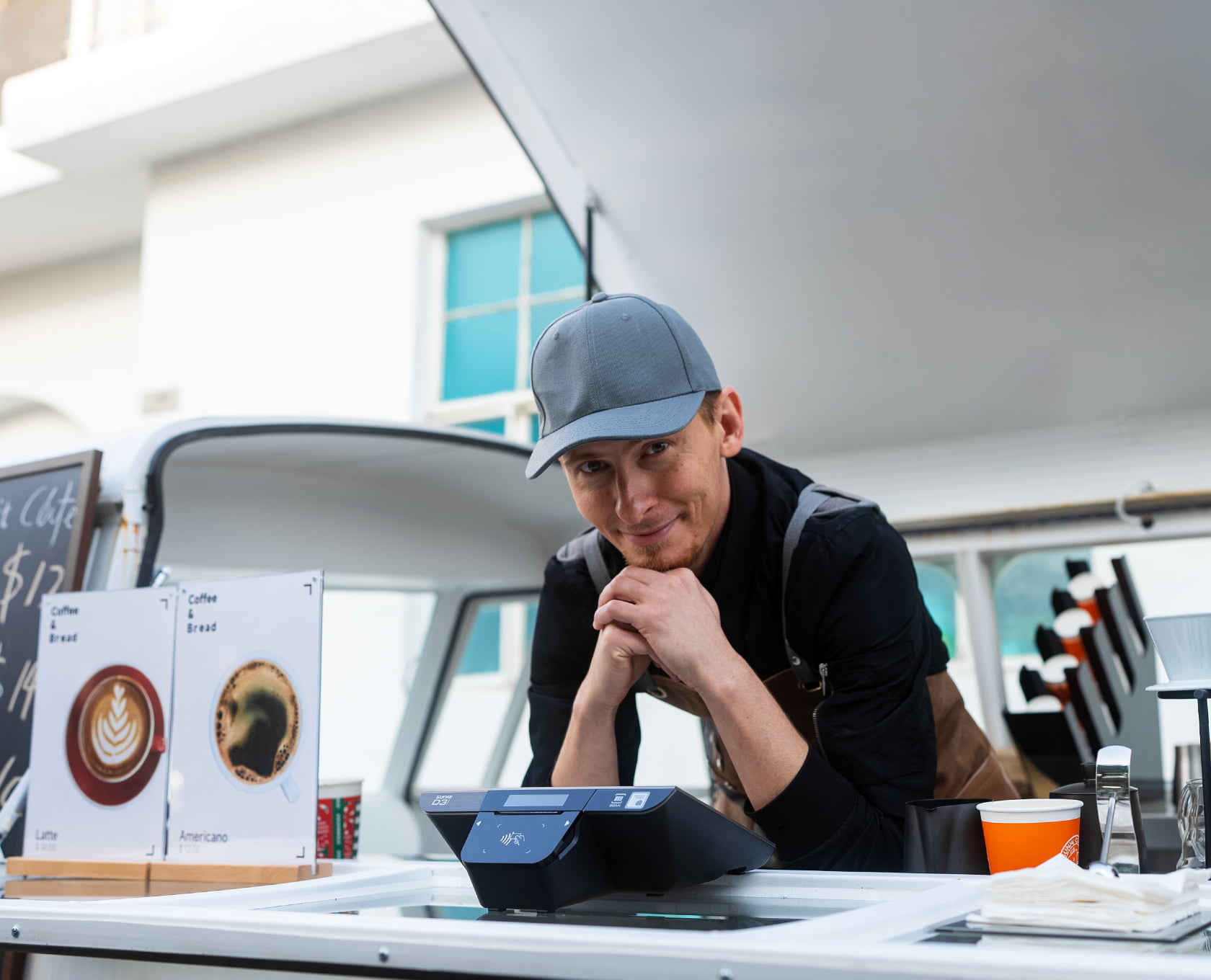 Sunmi D3 Mini on a coffee truck counter with its customer-facing tap-to-pay display, used by a food-truck vendor