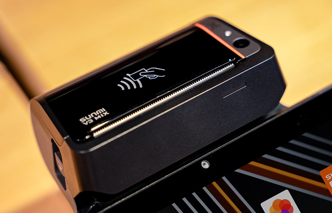 Close-up of the Sunmi V3 MIX showing the on-device NFC tap-to-pay symbol and built-in 80mm printer